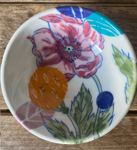 Tiny dish with bright pink poppy